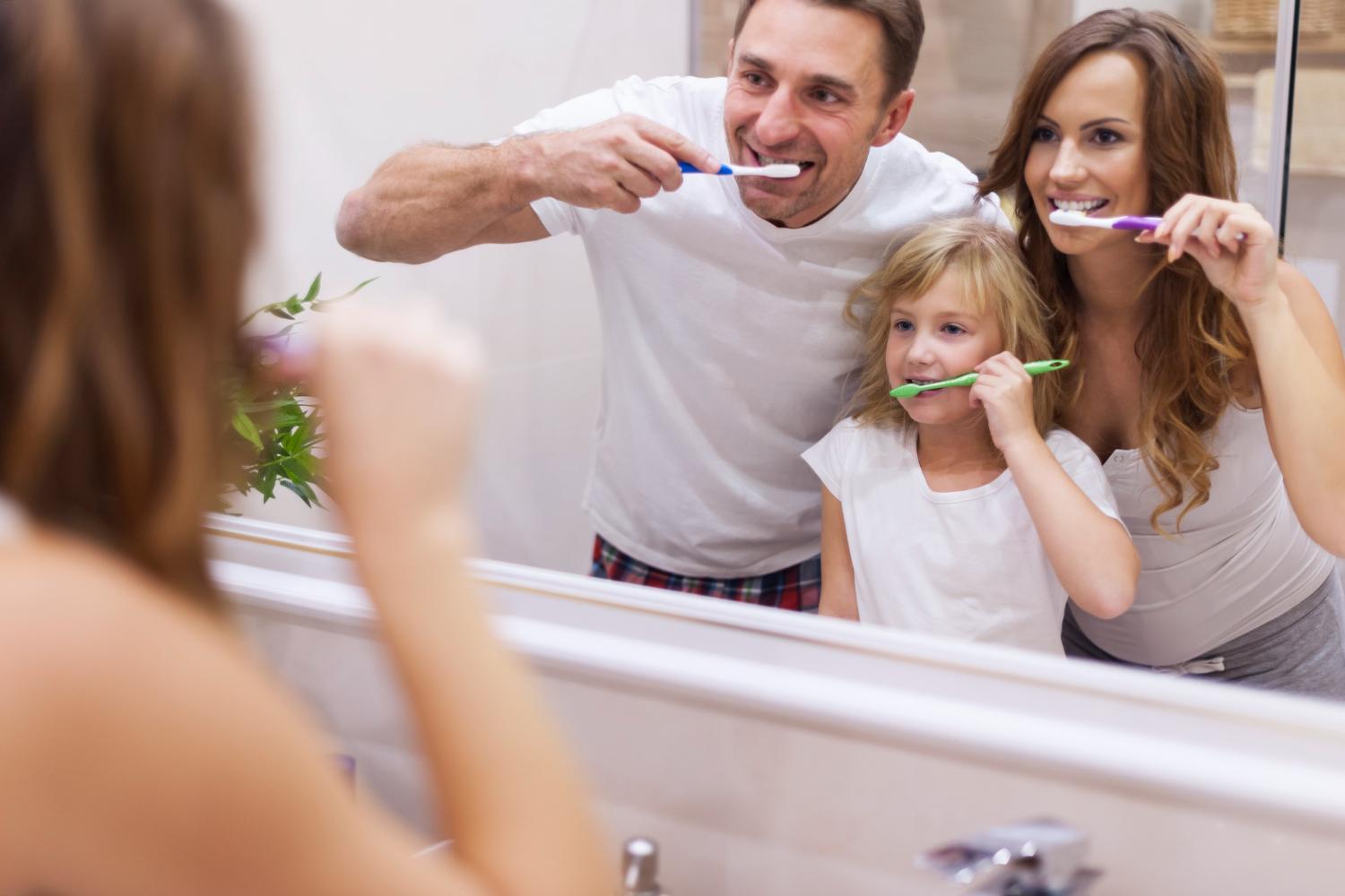 family brushes teeth