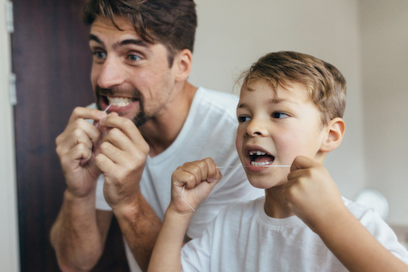 father and son flossing