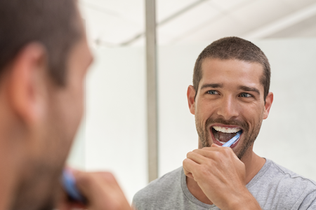 man brushing teeth
