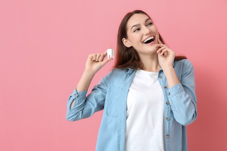 woman holding tooth