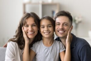 happy family smiling, little girl with parents, healthy white smiles