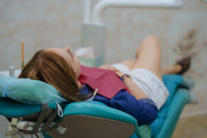 young woman relaxing in a dental chair, dental sedation