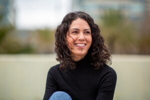 portrait of a smiling woman outdoors, perfect white teeth